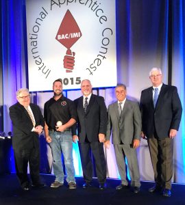 Chase Owens receives the his first place trophy in PCC at the 2015 BAC/IMI International Apprenticeship Contest.